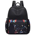 Black nylon backpack with ethnic floral print and multiple storage compartments - Beauty Portrait