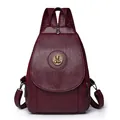 Deep burgundy PU leather backpack featuring a golden round animal relief metal buckle - Wine Red