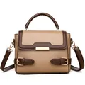 Contrast color leather handbag with pebbled texture and gold hardware on white background - Khaki