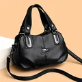 Classic black leather satchel with metal kangaroo emblem and adjustable shoulder strap - One Size / Black