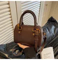 Detail of vintage brown Boston bag with textured leather, top handles and bronze hardware - One Size / Brown