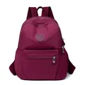 Fashionable burgundy waterproof nylon backpack with front zipper pocket and side pockets - Red