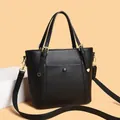 Elegant black lychee grain leather tote bag with gold hardware and wide shoulder strap - Black