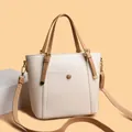 Elegant cream white bucket tote bag in pebbled leather with brown handles and gold hardware - White
