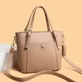 Elegant light brown tote bag with lychee texture and adjustable strap in studio setting - Khaki