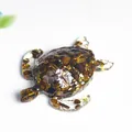 Resin sea turtle figurine with natural crystal tiger eye and gold foil on white background - Tiger's Eye