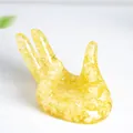 Yellow thumb-shaped crystal sphere base made of resin and crushed stone filler - Citrine