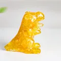 Resin dinosaur statue with yellow crystal stone fragments in a T-Rex dragon shape - Citrine