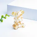 Detail of crystal resin bear ornament with internal gold leaf and gear elements - White Shell
