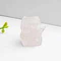 Macro shot of hand-carved pink quartz Lucky Cat figurine with translucent stone texture - Rose Quartz