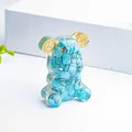 Blue crystal stones and gold gears inside a bear resin statue desk ornament - Turquoise