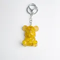Yellow crystal bear keychain with transparent resin and golden gears on white background - Yellow Agate Style