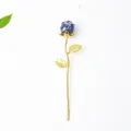 Golden rose resin ornament with deep blue lapis lazuli flower bud on white backdrop - Lapis Lazuli