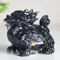 Macro detail of black crystal resin dragon turtle statue with embedded gold foil flakes - Obsidian Style