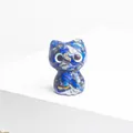 Detailed macro view of a handmade blue lapis lazuli resin cat figurine with cute eyes - Lapis Lazuli
