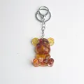 Brown natural crystal stone bear keychain with resin finish and golden gear detail - Red Agate