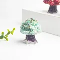 Detail of mint green crystal money tree ornament with purple resin base on desktop - Amazonite