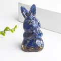 Translucent bunny ornament with blue crystal gravel and gold foil on white surface - Lapis Lazuli and Gold Foil