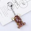 Handmade red resin bear keychain with gold foil and mechanical gears detail - Strawberry Quartz Style