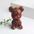 Crown bear ornament filled with red jasper crystals and gold foil on white stand - Red Jasper Style