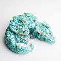 Macro shot of sleeping dragon figurine crafted from turquoise crystal stone resin - Turquoise