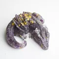 Detail of purple crystal resin dragon figurine with gold foil flakes on wings - Amethyst