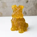 Detailed close-up of amber translucent schnauzer statue with intricate crystal textures - Citrine