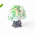 Handmade resin crystal money tree with colorful gemstone leaves on a dark grey base - Cat's Eye