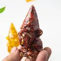 Macro detail of gnome statue made of natural red crystal stones and resin for home decor - Red Jasper