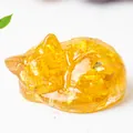 Amber yellow resin sleeping cat statue filled with natural crystal stones and gold foil - Citrine