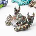 Macro shot of crab-shaped resin holder filled with colorful natural crystals and gold leaf - Ocean Jasper
