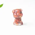 Detailed close-up of a resin schnauzer dog figurine with crystal stones and gold foil - Red Jasper