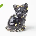 Macro shot of sitting cat figurine with black resin and embedded gold foil flakes - 3.2cm x 3.3cm x 4cm / Obsidian