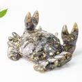 Macro detail of resin crab holder with natural crystal stones and gold foil flakes - Labradorite