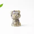 Macro detail of a resin cat figurine with natural crystal gravel and matte texture finish - Black Labradorite