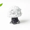 Mushroom-shaped decor made of white crystal chips and black resin base on white background - Howlite
