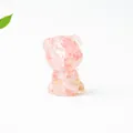 Detailed shot of pink crystal resin schnauzer cat figurine with gold foil flakes - Watermelon Quartz