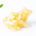 Cute resin frog figurine with amber yellow natural crystal stone infill on white background - Yellow Agate