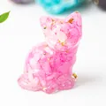 Close-up of pink crystal cat figurine with gold leaf accents and resin finish - Rose Red Crystal