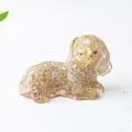 Detailed close-up of a resin dog ornament embedded with natural crystals and gold flakes - Rutilated Quartz