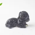 Macro shot of a glossy black resin dog figurine for desktop and home decoration - Obsidian