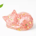 Pink natural crystal sleeping cat statue with gold foil accents for desk decor - Watermelon Quartz