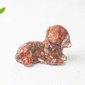 Detailed macro view of resin dachshund dog ornament with red natural crystal stones - Red Agate