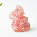 Detailed macro view of an elephant resin figurine filled with pink natural crystal stones - Watermelon Quartz