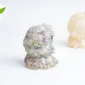 Detail of resin creature ornament embedded with purple and green fluorite crystals - Colorful Fluorite