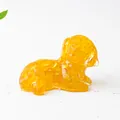 Detail of amber crystal resin dog figurine with transparent crushed stone texture - Citrine