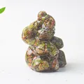 Macro detail of natural crystal stone resin elephant statue with vibrant mineral chips - Unakite