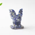 Detailed close-up of a gargoyle resin statue filled with natural lapis lazuli stones - Lapis Lazuli