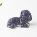 Macro shot of blue goldstone puppy figurine with shimmering star-like details - Blue Sandstone