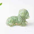 Close-up of a dog ornament made of green crystal gravel and transparent resin - Green Aventurine